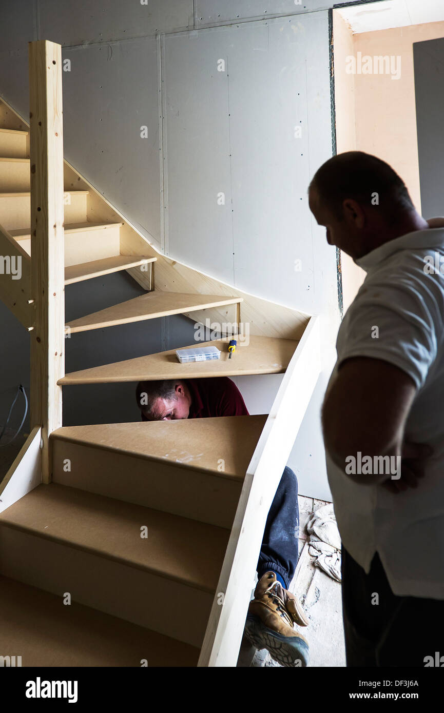 A carpenter building a wooden staircase in a house Stock Photo Alamy