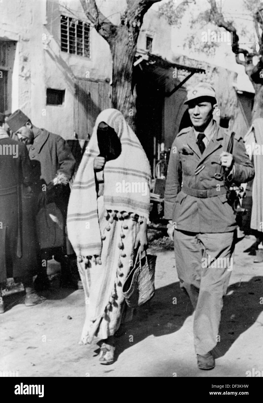 The image from the Nazi Propaganda! depicts a soldier of the German Wehrmacht with a local woman in a North African medina quarter, published on 25 March 1942. Place unknown. Fotoarchiv für Zeitgeschichte Stock Photo