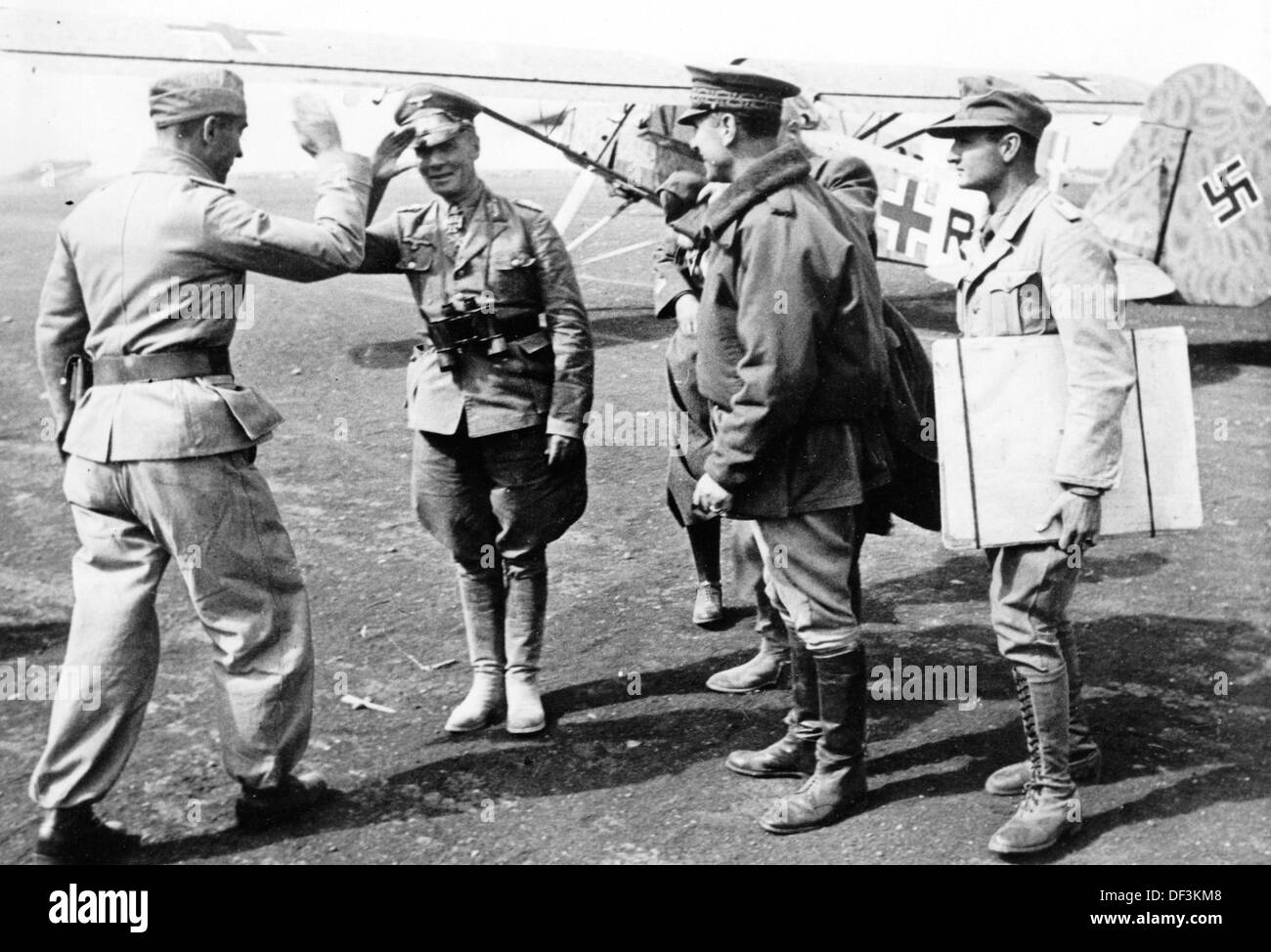 Field Marshall Erwin Rommel (2-l) is pictured on a combat airfield in northern Africa during the occupation of Tobruk in June 1942. The Nazi Propaganda! on the back of the image is dated 22 June 1942: 'Meeting of generals with Colonel General Rommel. Arrival of German and Italian generals at the combat airfield in north Africa.' Fotoarchiv für Zeitgeschichte Stock Photo