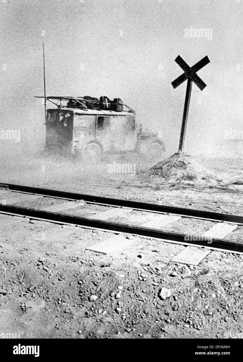 The image from the Nazi Propaganda! depicts a vehicle of the German Wehrmacht as it crosses th railway tracks of the desert railway between Marsa Matruh and Alexandria in Egypt, published on 10 July 1942. Fotoarchiv für Zeitgeschichte Stock Photo