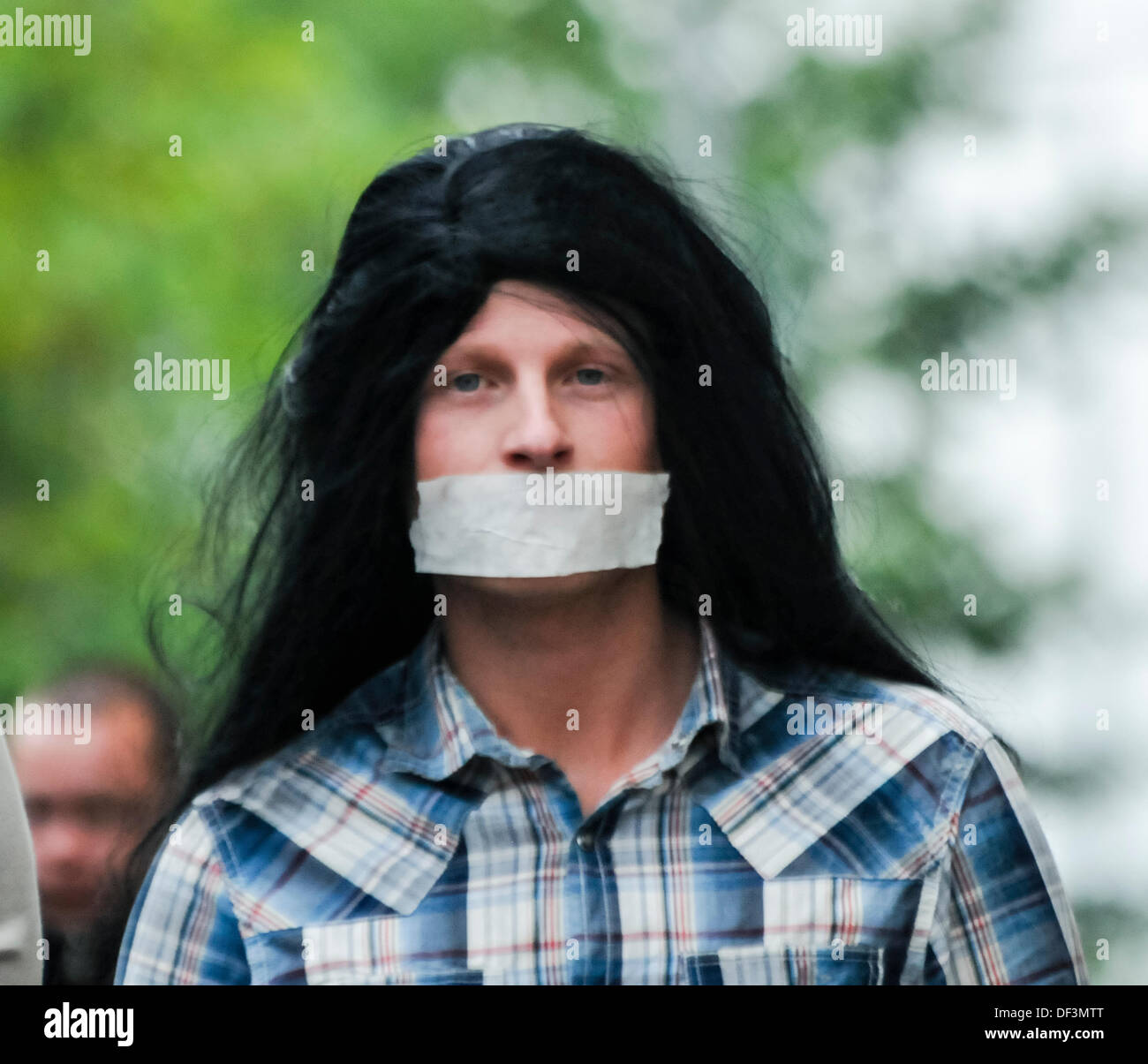 Belfast, Northern Ireland, 27th September 2013 - Jamie Bryson wears a wig and tape across his mouth as he accompanies Protestant Coalition founder member Willie Frazer as he appears in court dressed as Abu Hamza. Credit: Stephen Barnes/Alamy Live News Stock Photo
