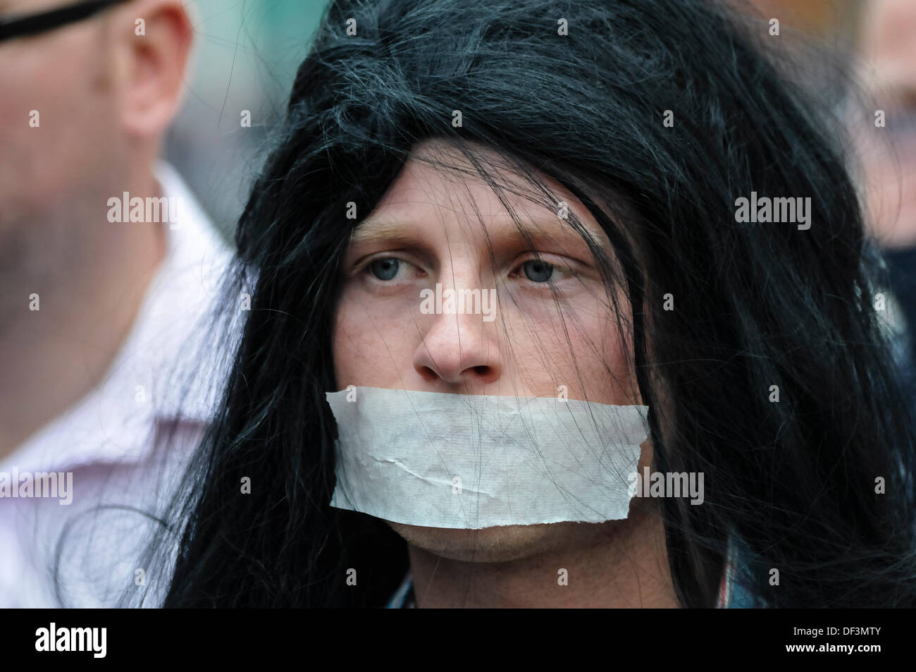 Belfast, Northern Ireland, 27th September 2013 - Jamie Bryson wears a wig and tape across his mouth as he accompanies Protestant Coalition founder member Willie Frazer as he appears in court dressed as Abu Hamza. Credit:  Stephen Barnes/Alamy Live News Stock Photo