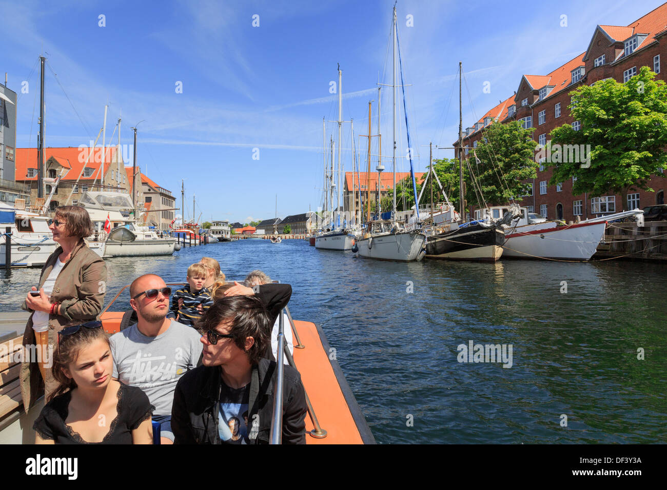 Tourists' sightseeing cruise boat on the Christianshavns Kanal, Overgaden, Christianshavn, Copenhagen, Zealand, Denmark Stock Photo