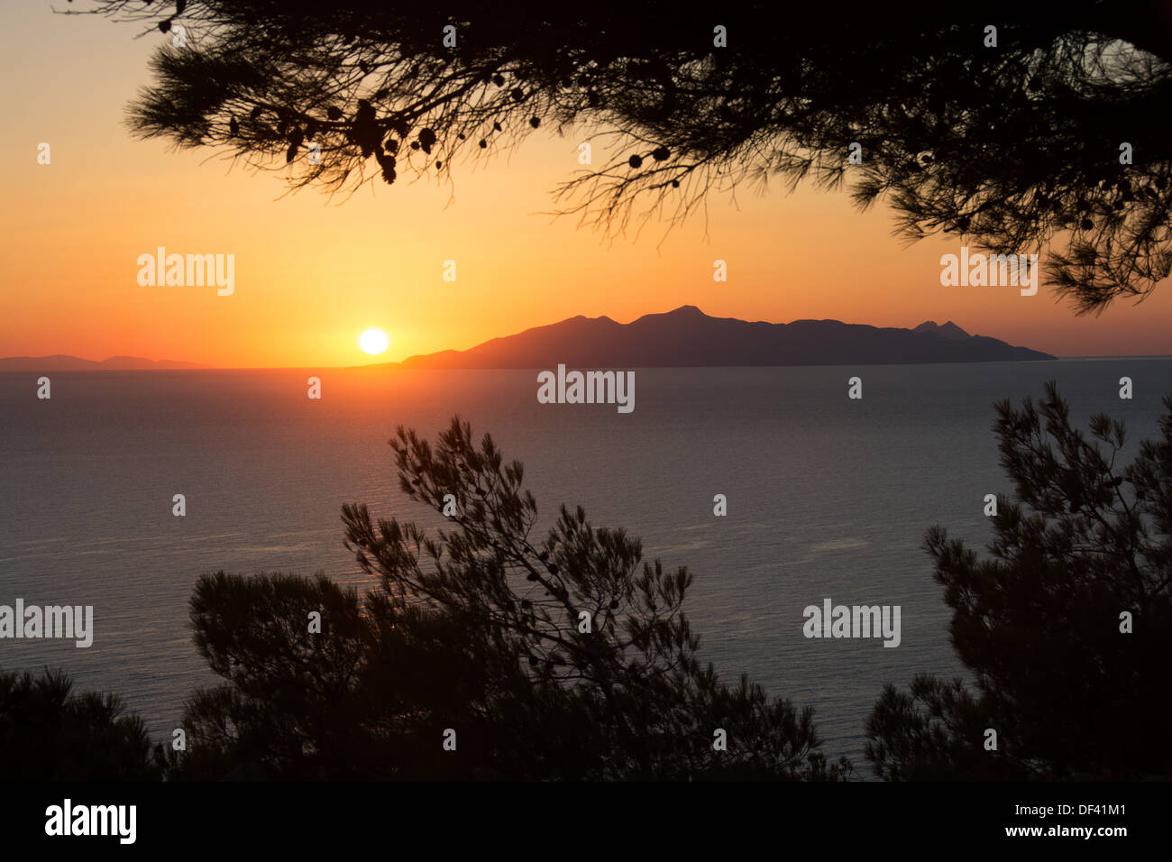 Sunrise over the Aegean as seen from Kamari on Santorini. The island in the distance is Anafi. 2013. Stock Photo