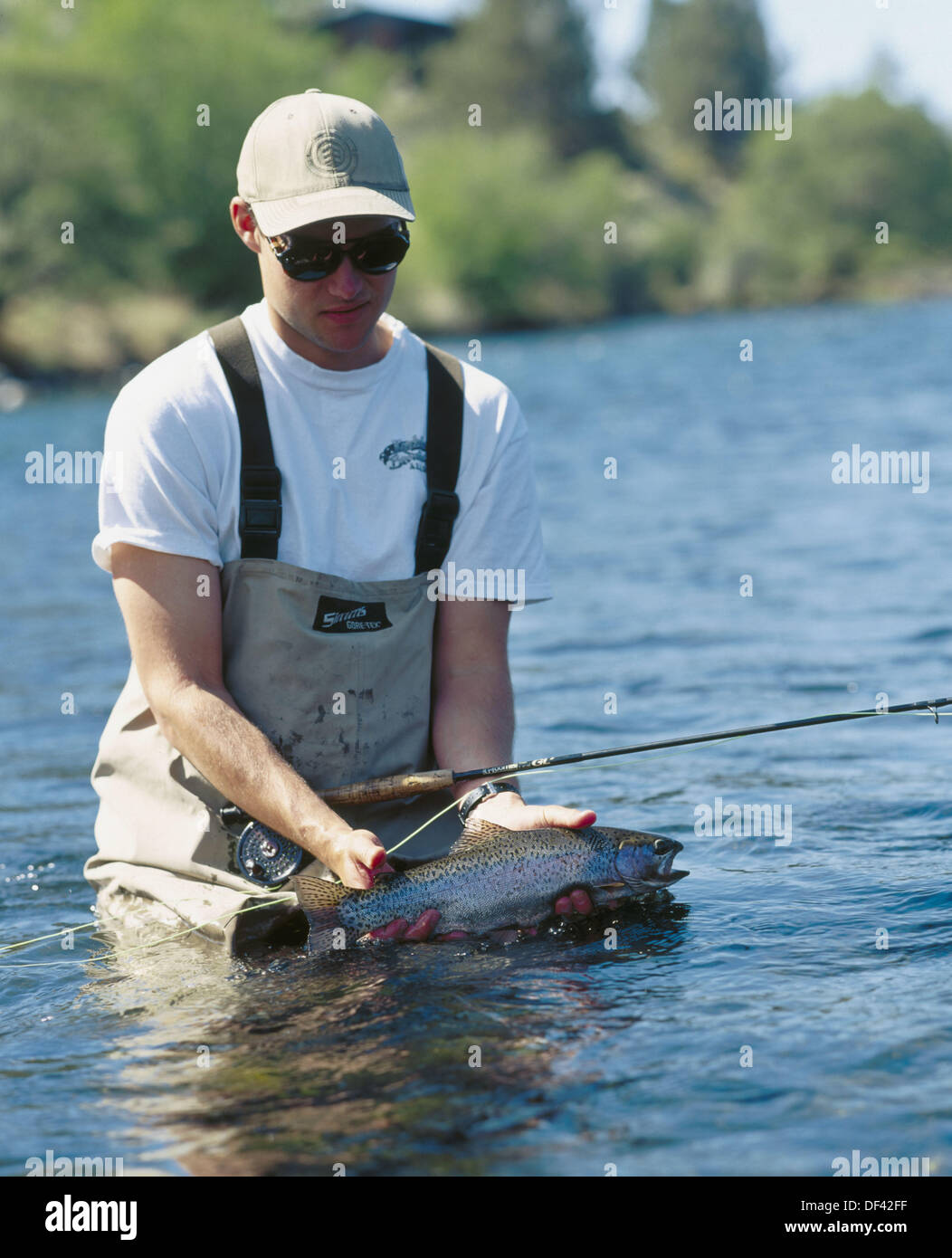 Fisherman holding trout flyfishing. Deschutes River. Warm Springs