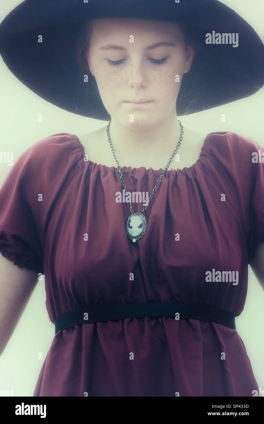 a sad young girl with black sunhat Stock Photo