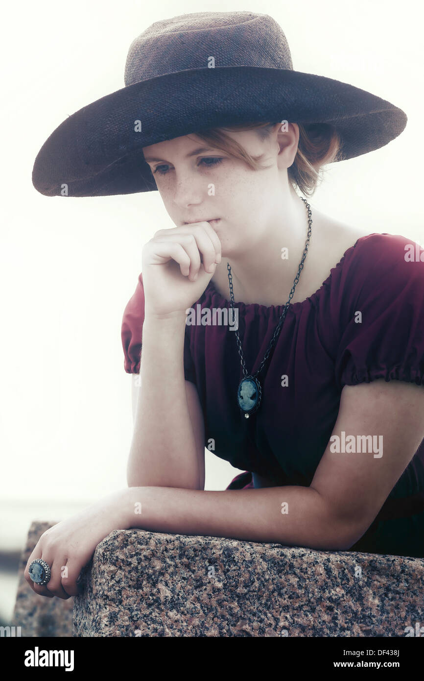 a sad young girl with black sunhat Stock Photo