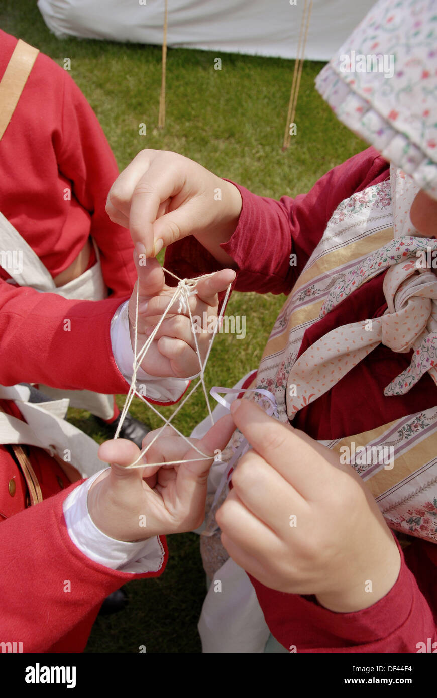 Children play a historical version of a string game Stock Photo Alamy
