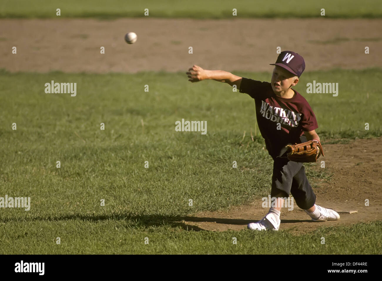 10 year old boy playing little league baseball throwing a ball Stock Photo