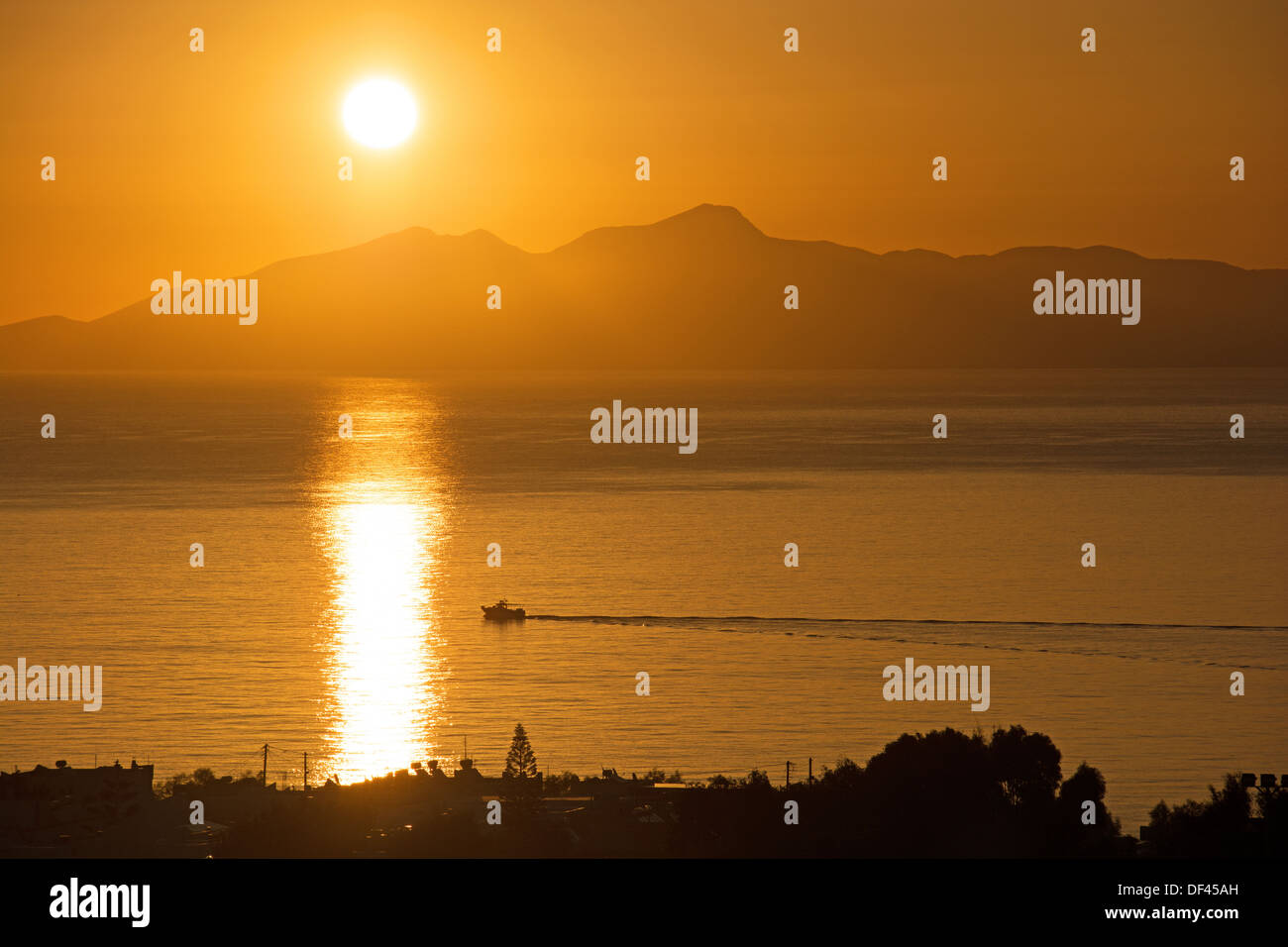 CYCLADES, GREECE. Sunrise over the Aegean island of Anafi, as seen from Kamari on Santorini (Thira). 2013. Stock Photo