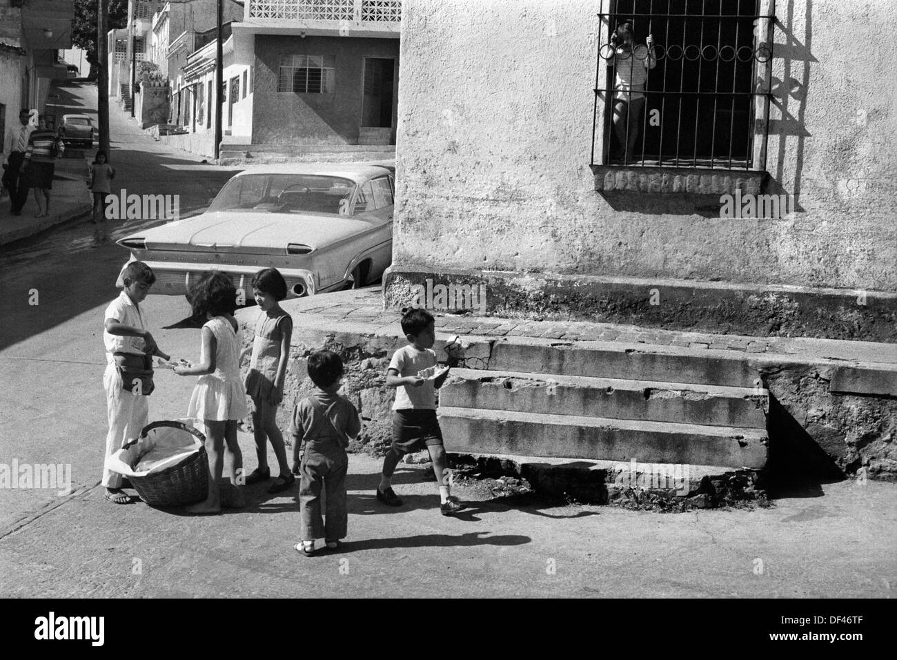 Mazatlan Mexico 1970s. Teen boy working selling food snacks to other children.  Rich, poor, poverty  economic divide.  1973 State of Sinaloa,   HOMER SYKES Stock Photo