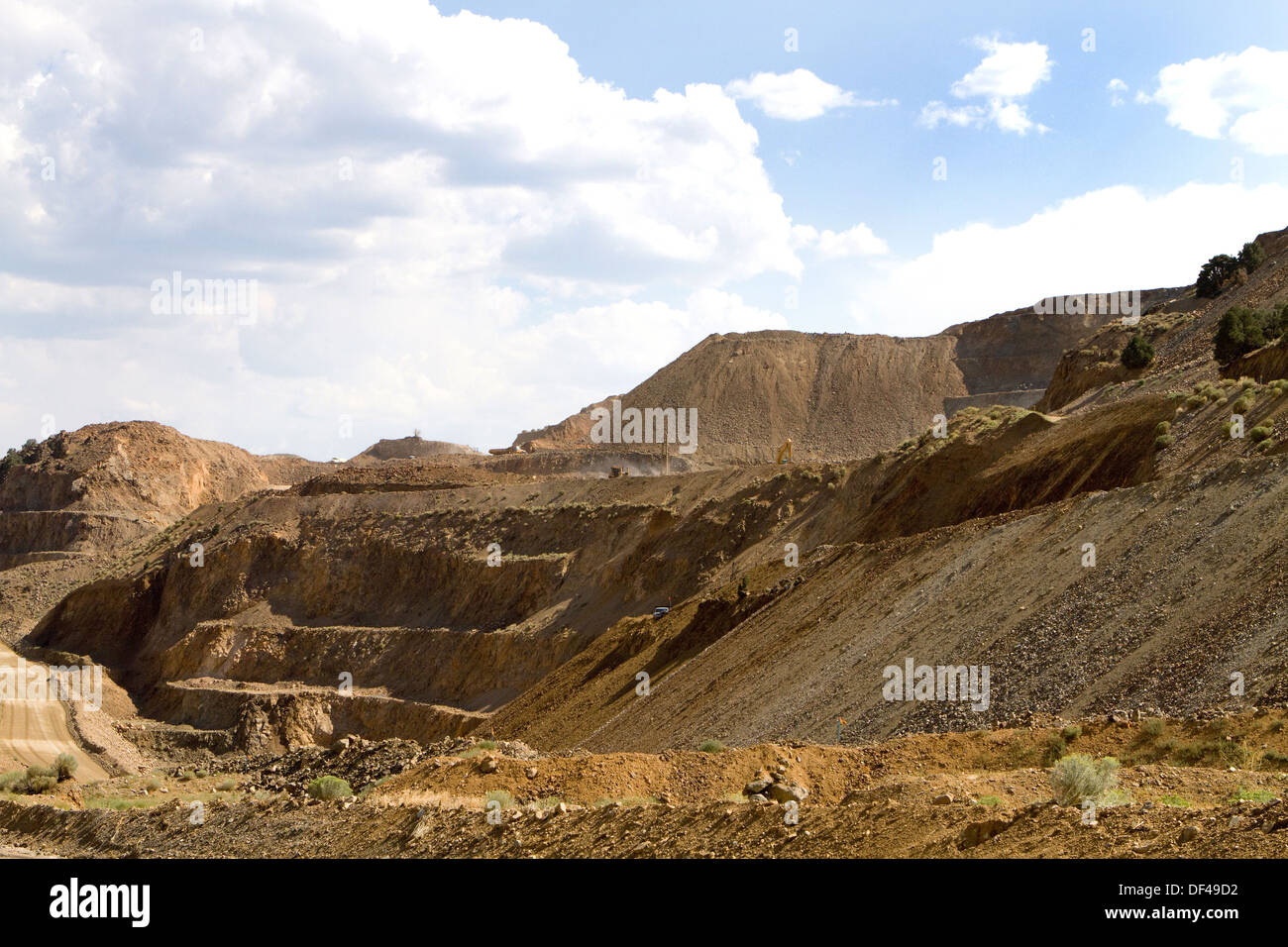 Miners excavate for silver ore at an open strip mine operation in the Nevada mountains. Stock Photo