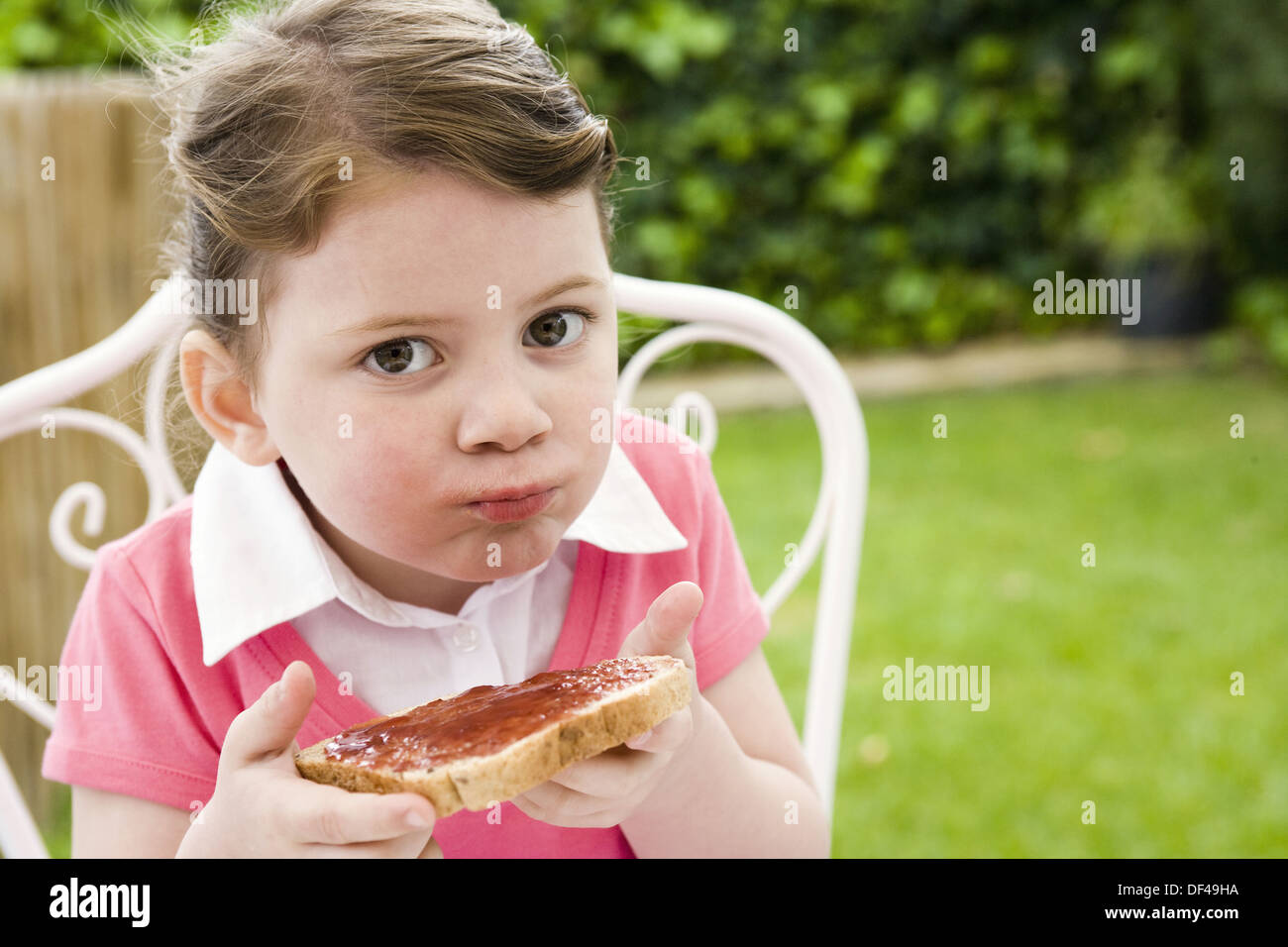 Little girl eating bread with jam Stock Photo Alamy