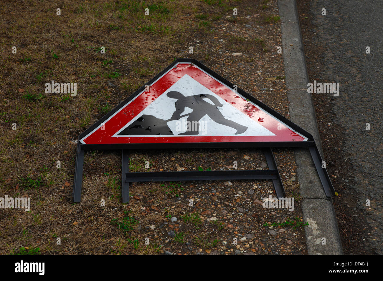 Road works sign laid down at side of road Stock Photo