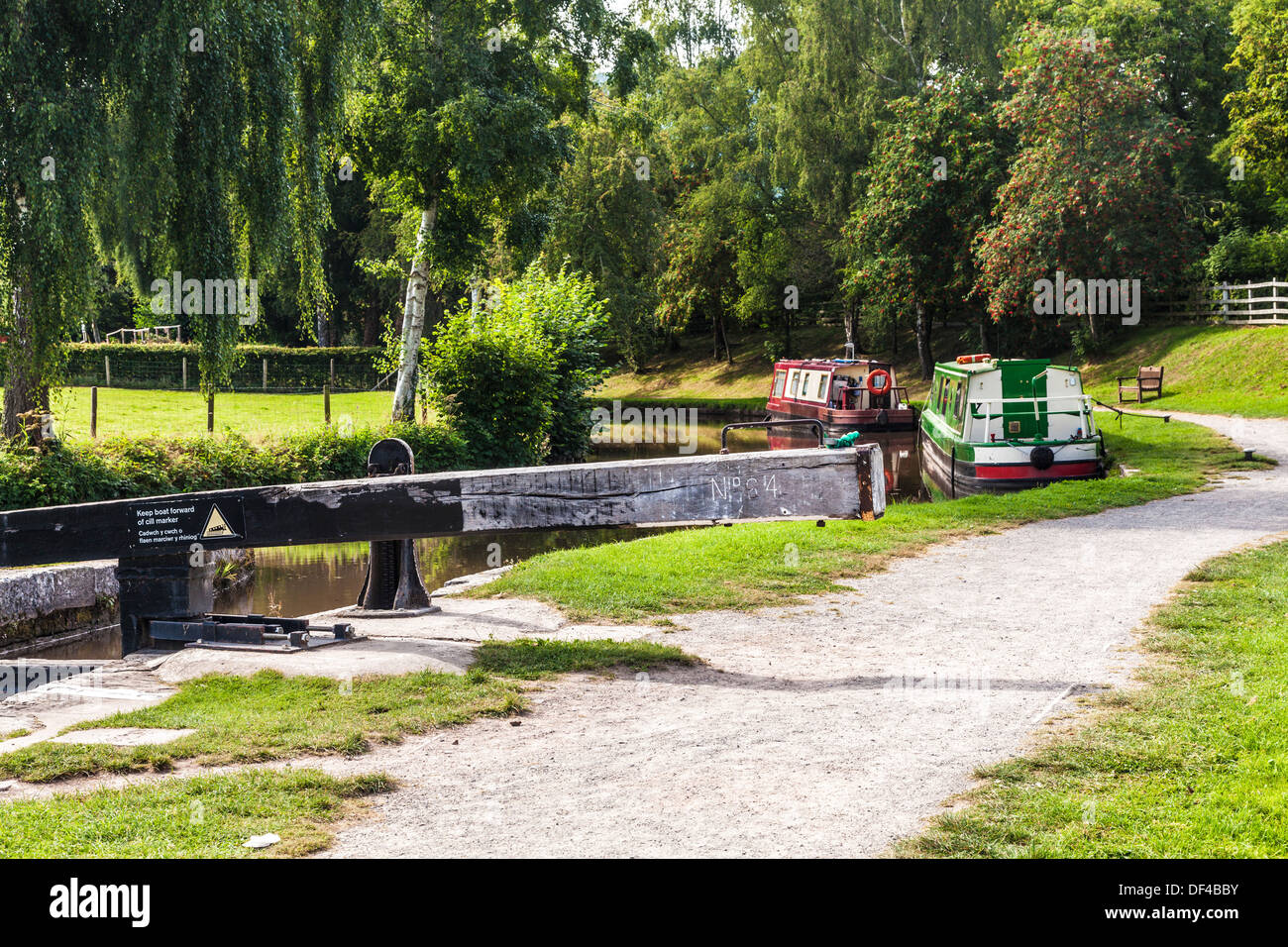 Narrowboats moored along the Monmouthshire and Brecon Canal at Llangynidr lock in the Brecon Beacons National Park. Stock Photo
