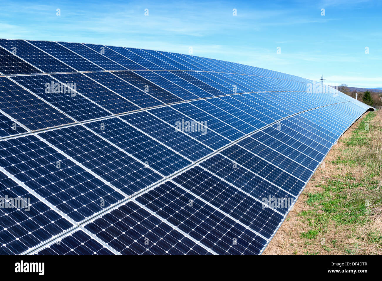 Field with many solar cells in front of a blue sky Stock Photo