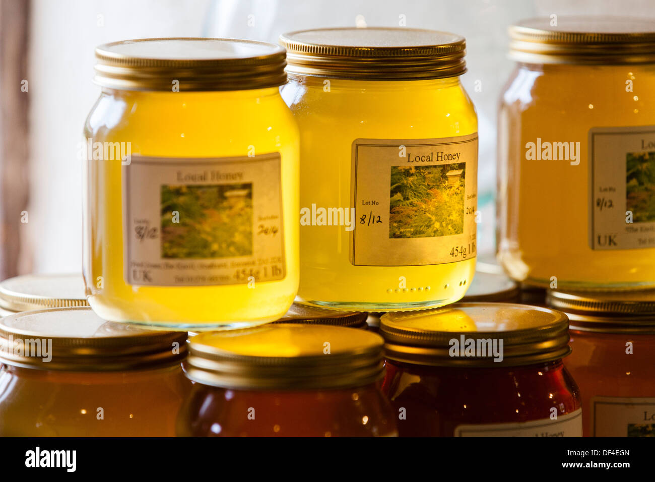 Jars of stacked Organic, home made honey on a window sill Stock Photo