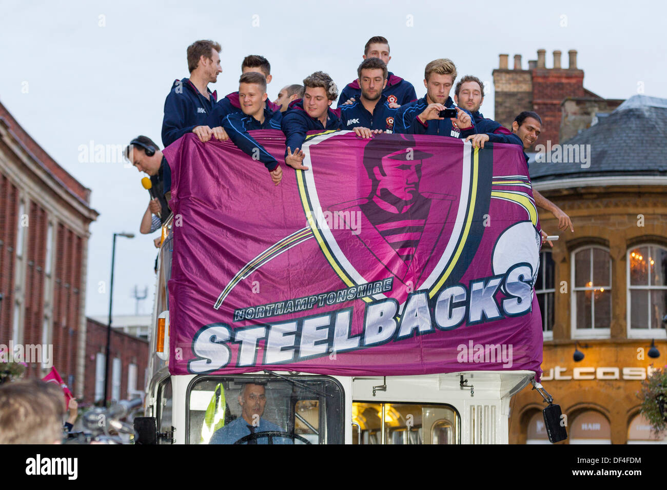 Northampton, UK . 27th Sep, 2013. The Steelbacks, Northamptonshire County Cricket Team parade the Friendslife T20 trophy through the Town Centre to a civic reception at the Guildhall. The team set off from the county ground at 6.15pm in an open-top bus and parade the T20 trophy through St Giles Street before arriving at the Guildhall for the reception.The Steebacks have completed one of the most successful seasons in the team’s history. Credit:  Keith J Smith./Alamy Live News Stock Photo