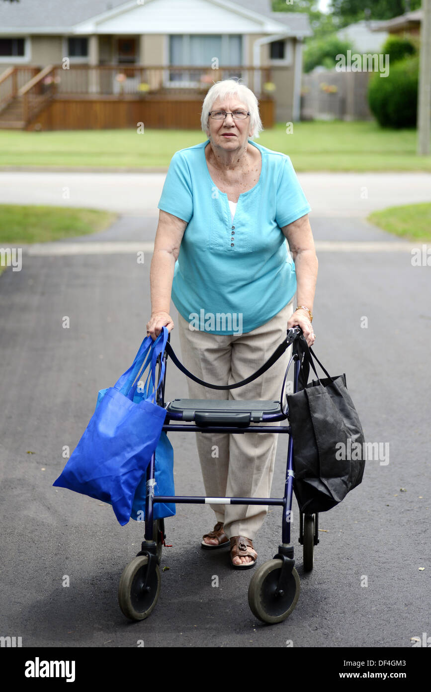 Stock Photo. senior woman and walker overloaded with shopping bags Stock Ph...