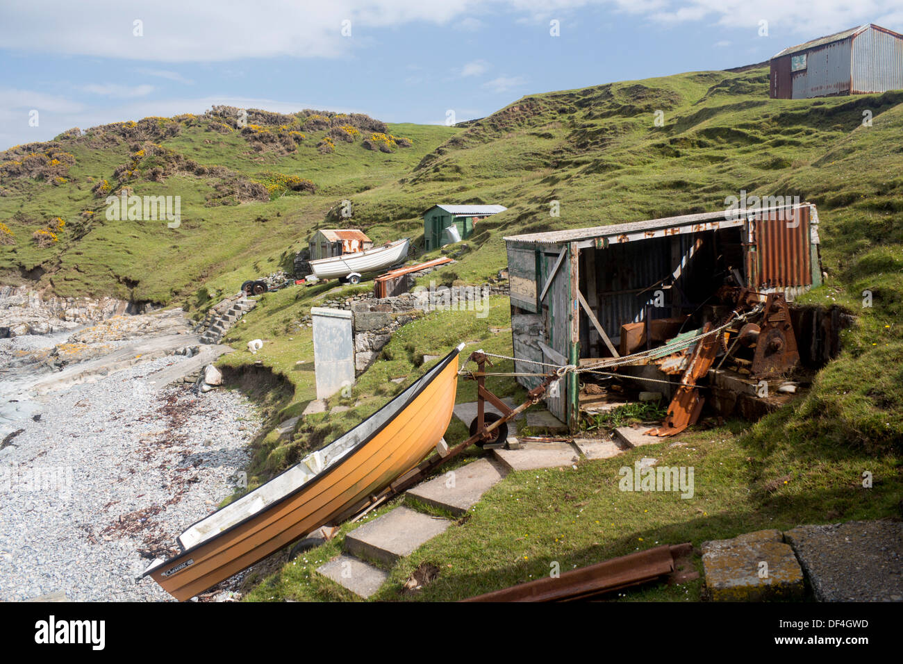 Porth Ysgaden Beach boats and rusty fishing huts Llyn Peninsula Gwynedd