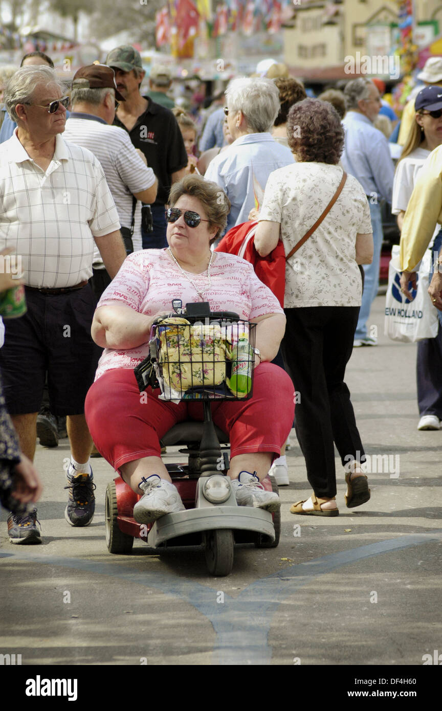 People confined to wheelchairs and walkers at the Florida State Fair grounds Seniors Stock Photo