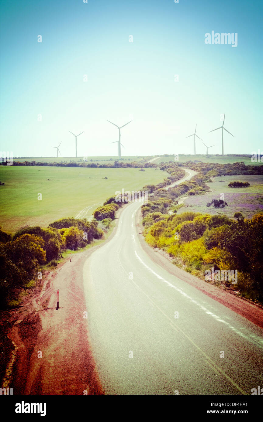 A lonely road curves toward Walkaway windfarm in remote Western Australia, with Instagram effect. Stock Photo