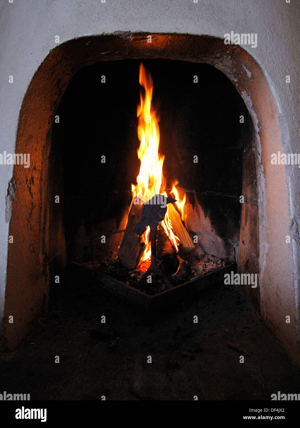 Burning Logs in Primitive Fireplace Stock Photo