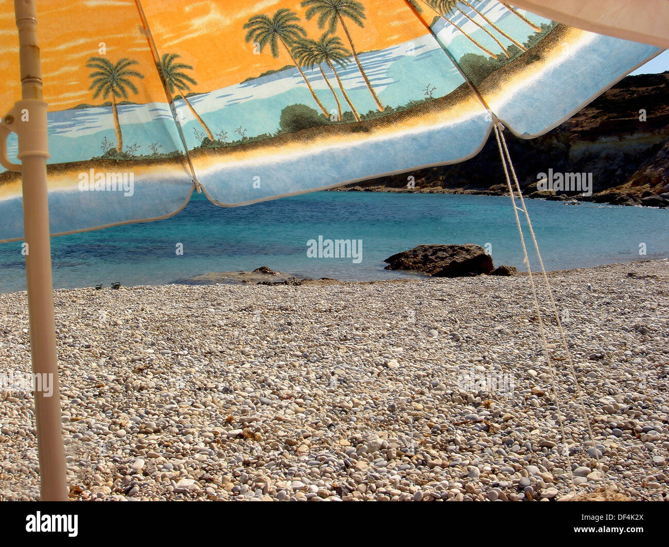 Shade Umbrella on Rocky Beach, Greece Stock Photo