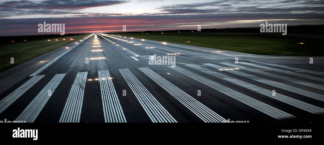 Illuminated Airplane Runway at Sunset Stock Photo
