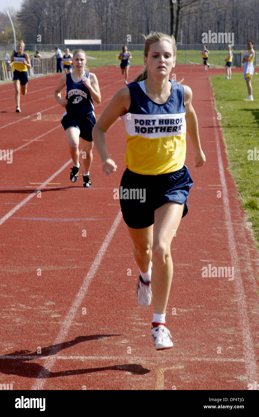 Girl runner wins half mile high school track race Stock Photo Alamy