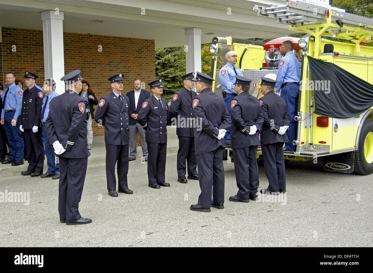 Funeral procession for a fire chief a fire engine acted as hearse and
