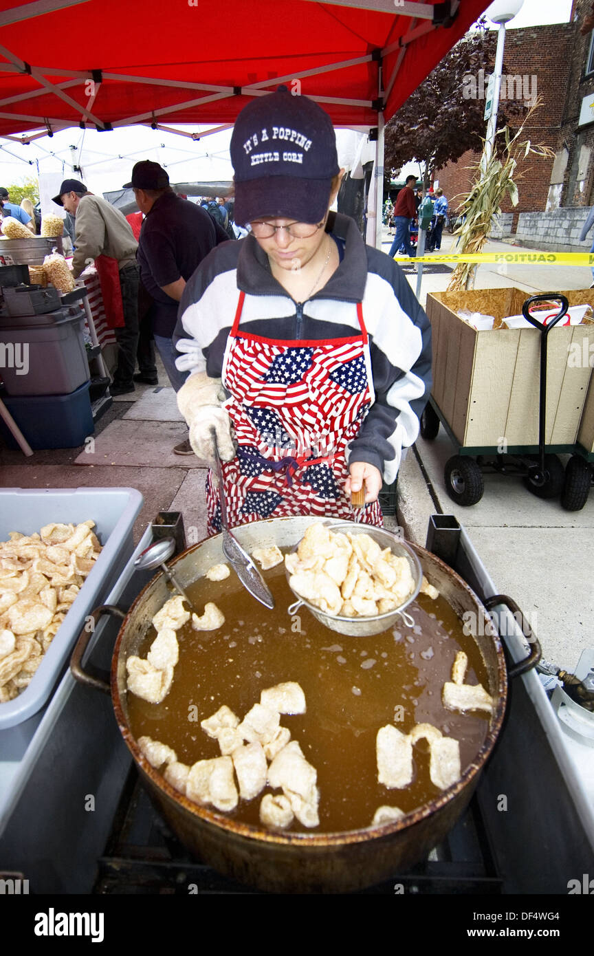 Female makes low carb pork rinds at a public event Stock Photo