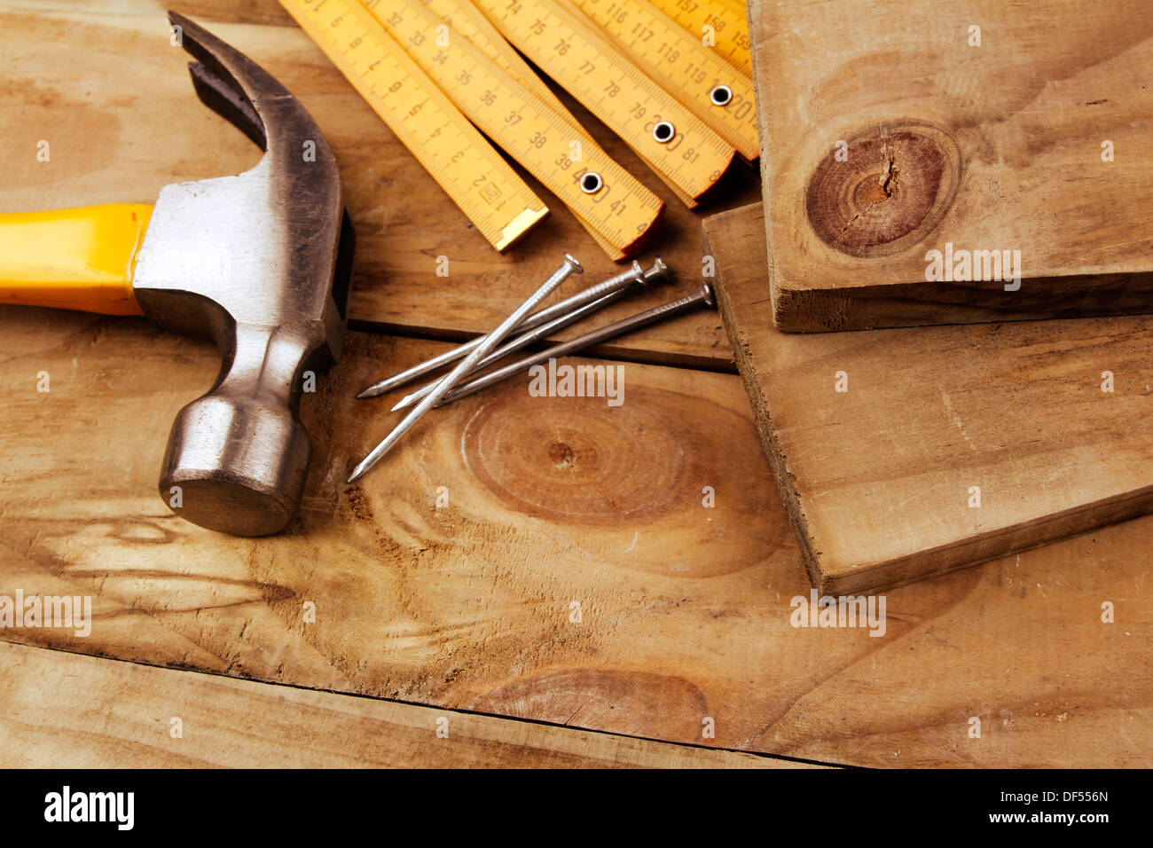 Nails, hammer and folding ruler on wood Stock Photo