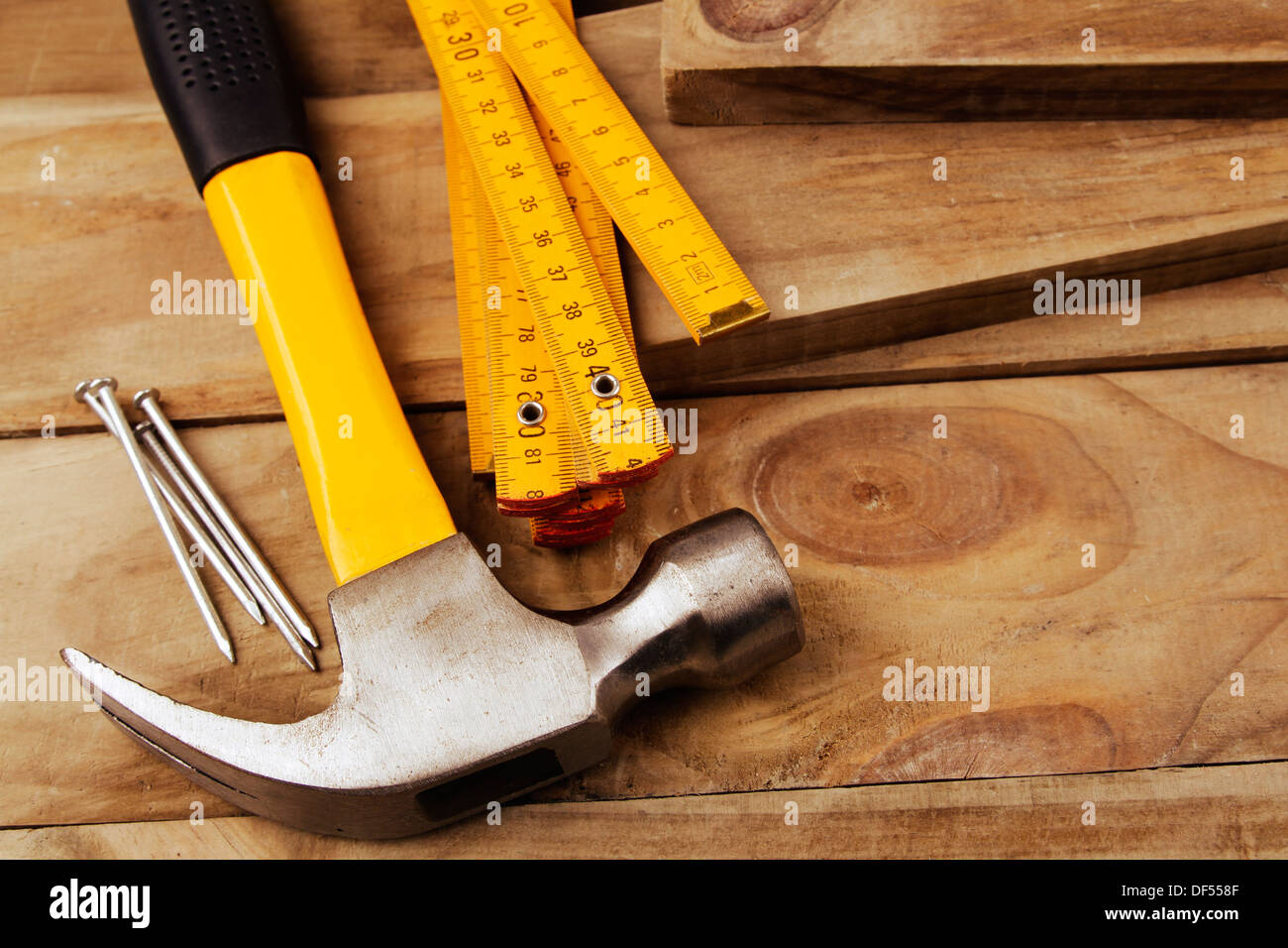 Nails, hammer and folding ruler on wood Stock Photo