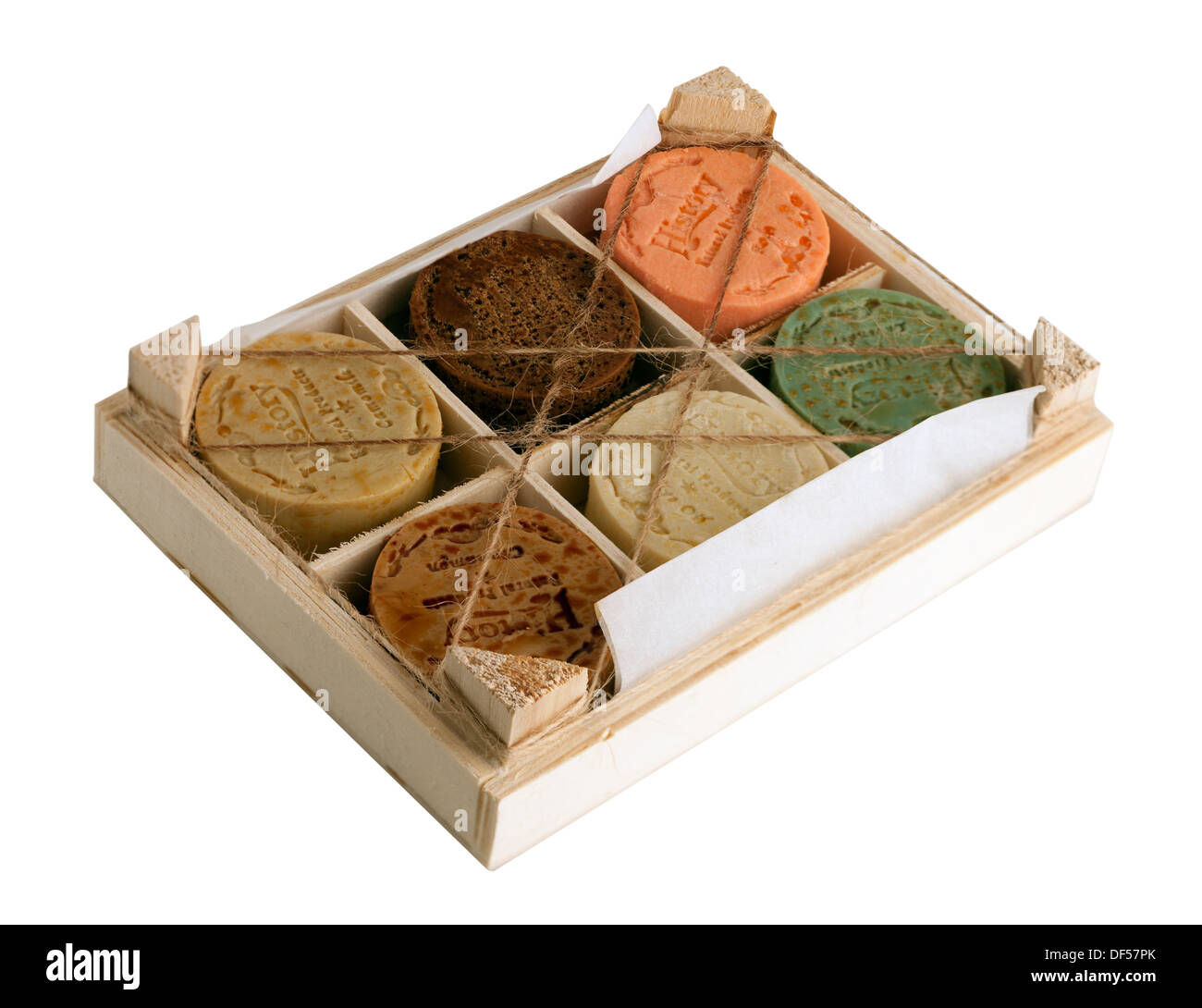 Wooden box containing six mixed circular soaps Stock Photo
