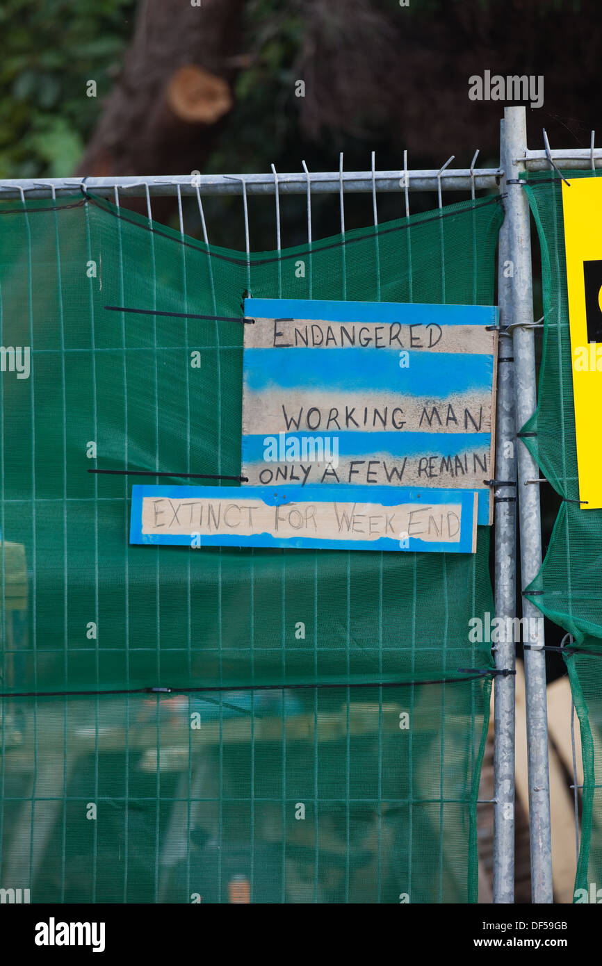 Free hand written Sign. Executed and displayed with a sense of humour, alongside a building contractor's security fence line. Stock Photo