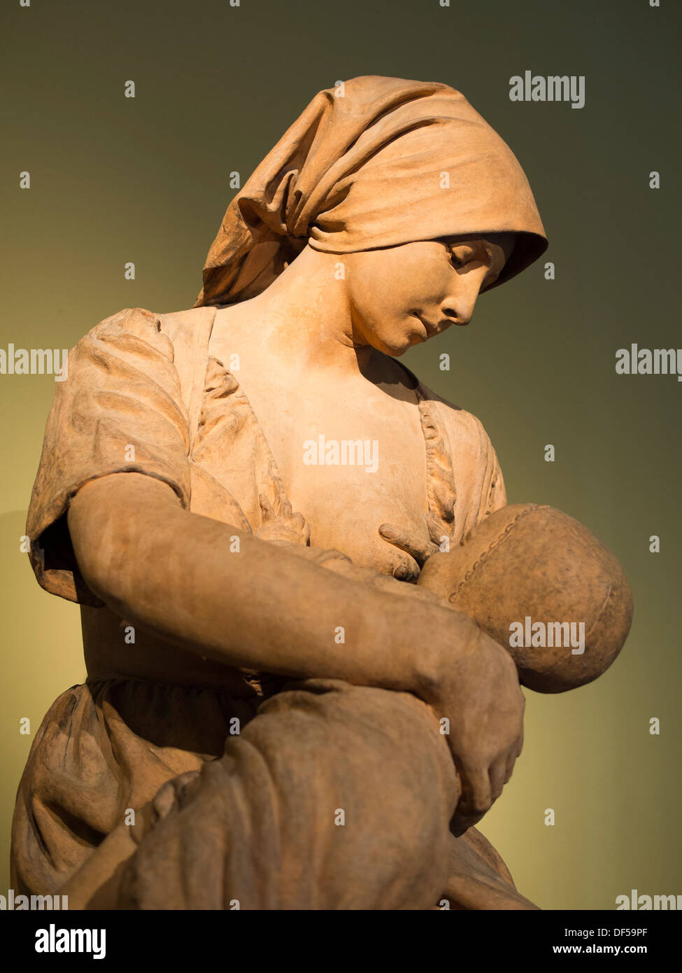 The Victoria and Albert Museum, London - touching sculpture of a peasant woman nursing a baby, by Aime-Jules Dalou Stock Photo
