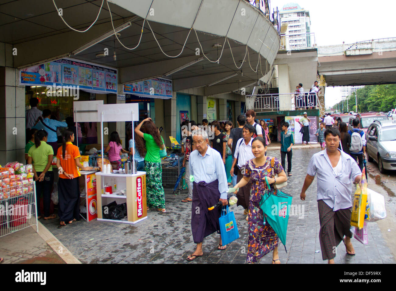 People walk past the Ruby Mart department store in Yangon, Burma Stock