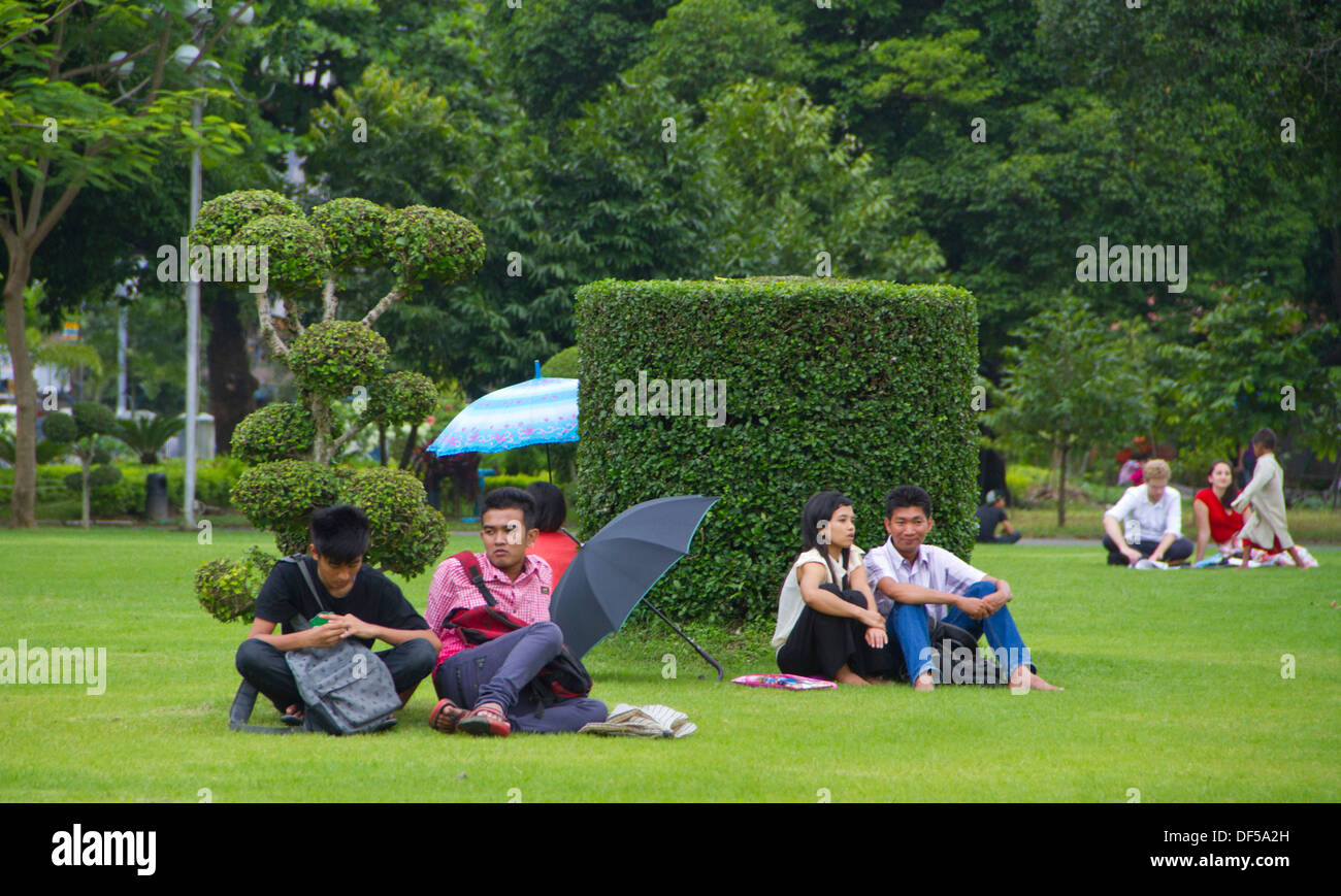 People relax in Mahabandoola Garden Park in Yangon, Burma. Stock Photo
