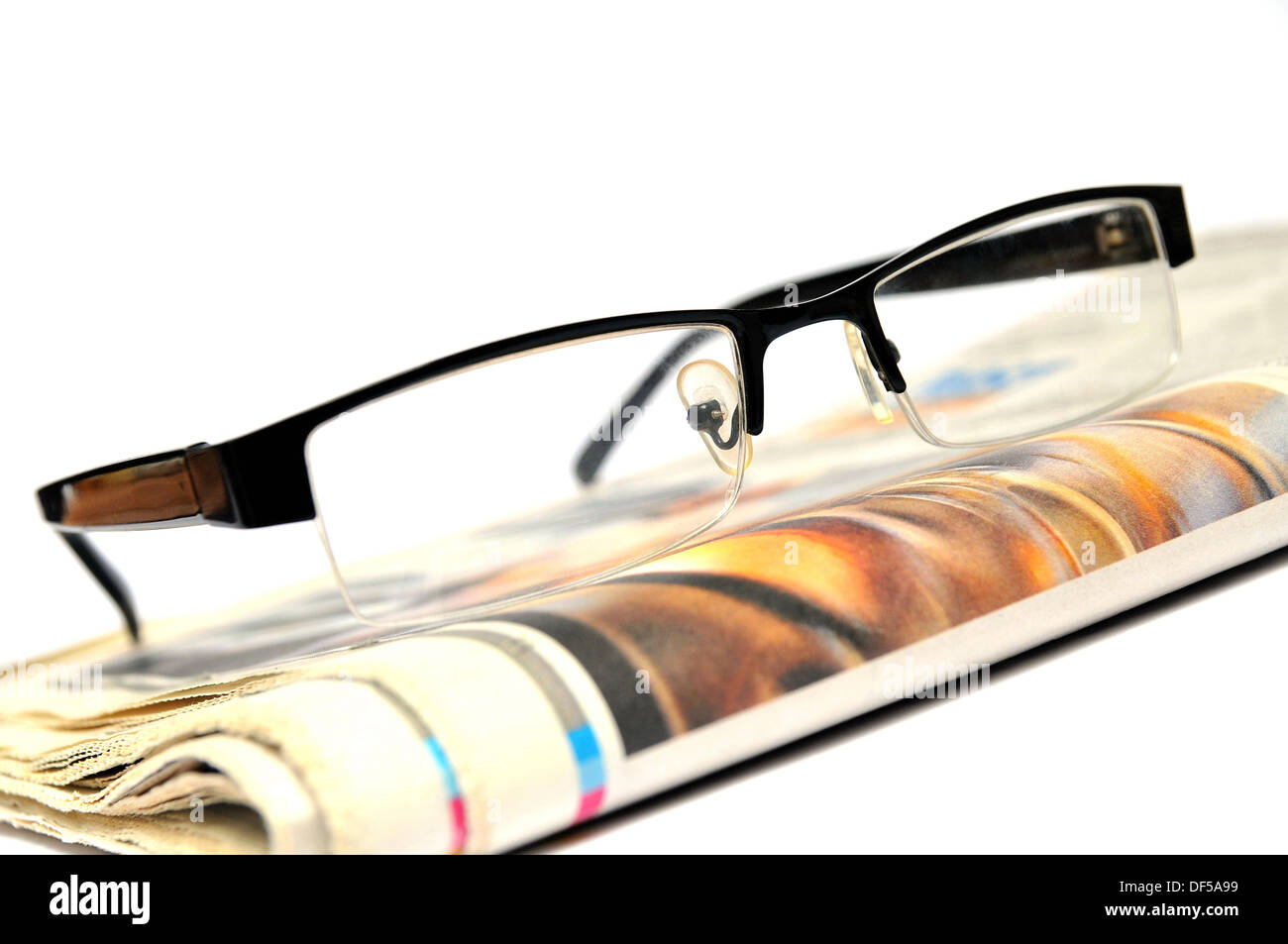 Stack of newspapers with glasses on top Stock Photo