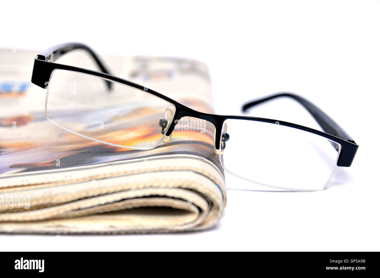 Stack of newspapers with glasses on top Stock Photo
