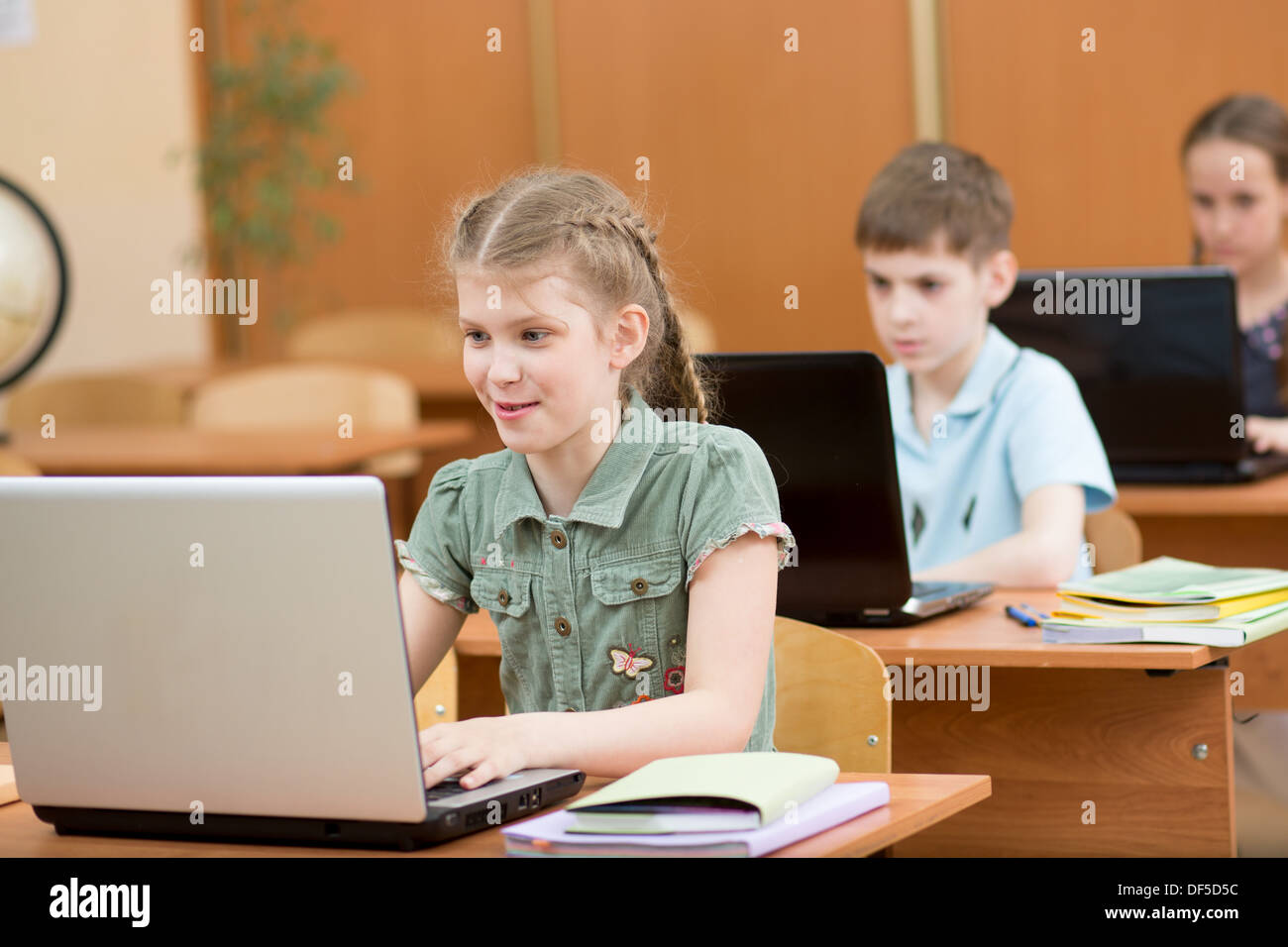 school kids using laptop at lesson Stock Photo