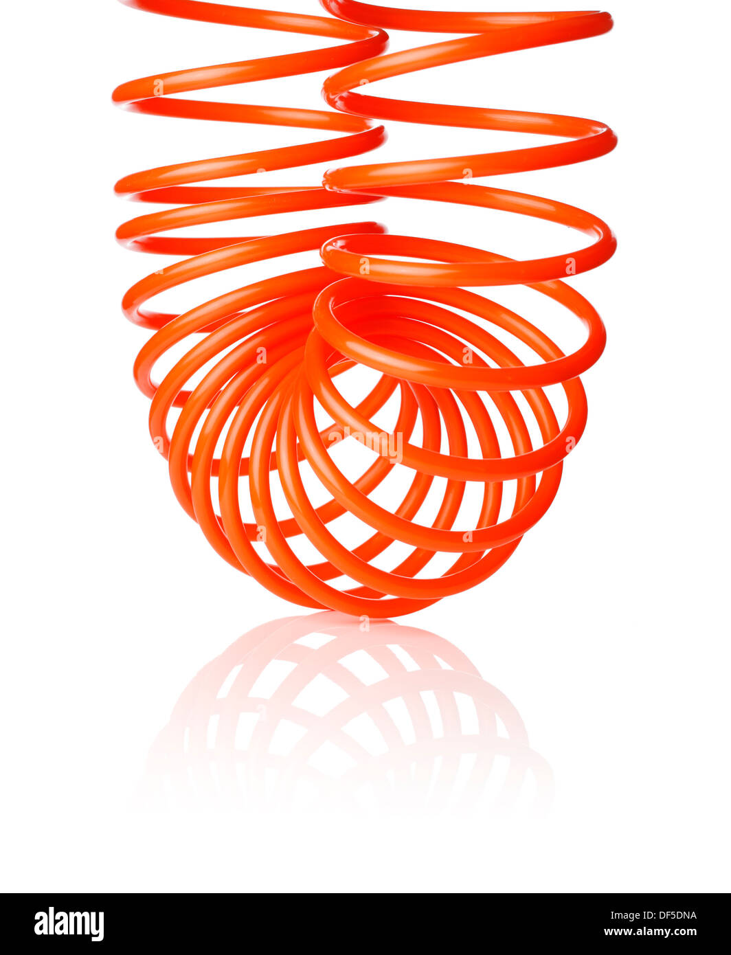 Orange red thin spiral air hose used for pneumatic tools, isolated on white with natural shadow. Stock Photo