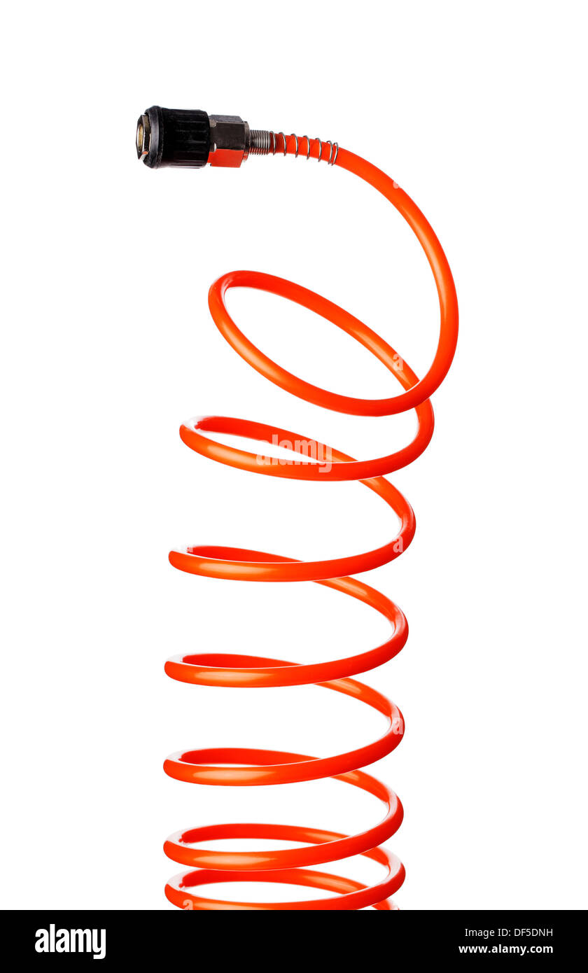 Orange red thin spiral air hose used for pneumatic tools. Stock Photo