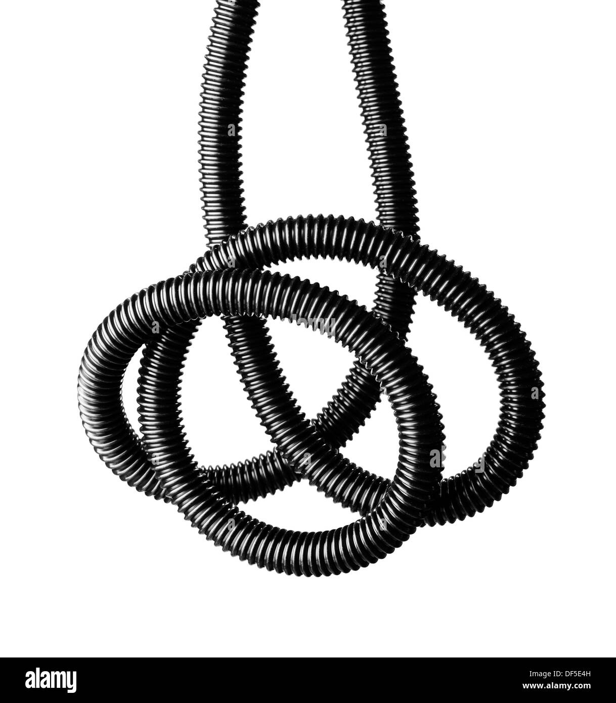 Black and white image of a black tangled flexible hose. Stock Photo