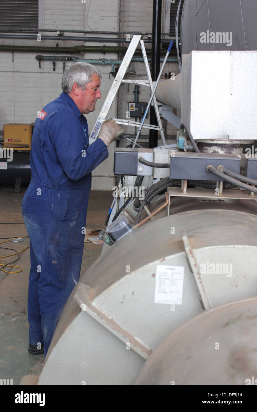 Painting a large steam boiler after a refit Stock Photo Alamy
