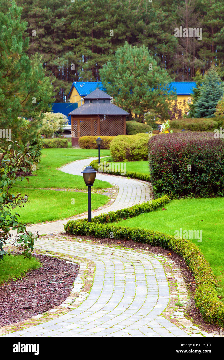 walkway in a lush green park Stock Photo - Alamy