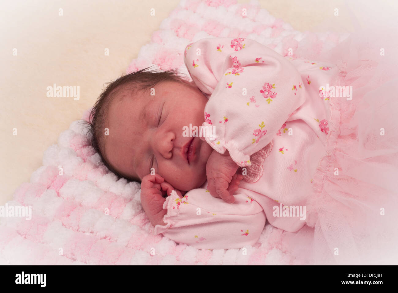 Beautiful newborn baby girl in pink on handmade blanket Stock Photo