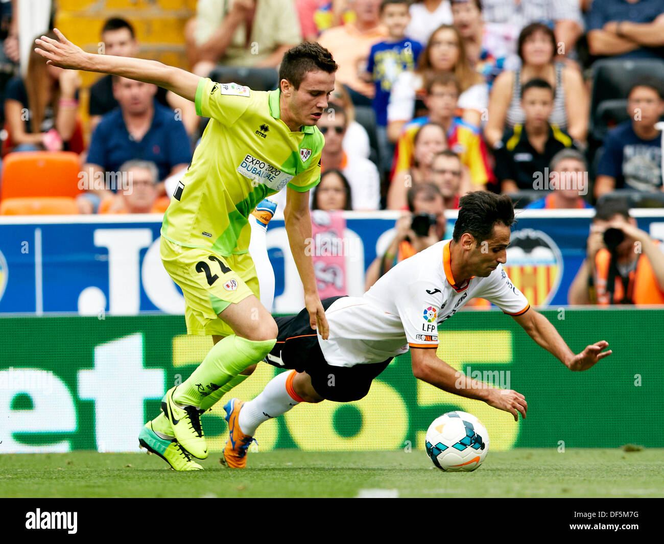 Valencia, Spain. 28th Sep, 2013. Forward Jonas Gonsalves of Valencia CF (R) falls after being challenged by Midfielder Saul Niguez of Rayo Vallecano during the La Liga Game between Valencia and Rayo Vallecano at Mestalla Stadium, Valencia Credit:  Action Plus Sports/Alamy Live News Stock Photo