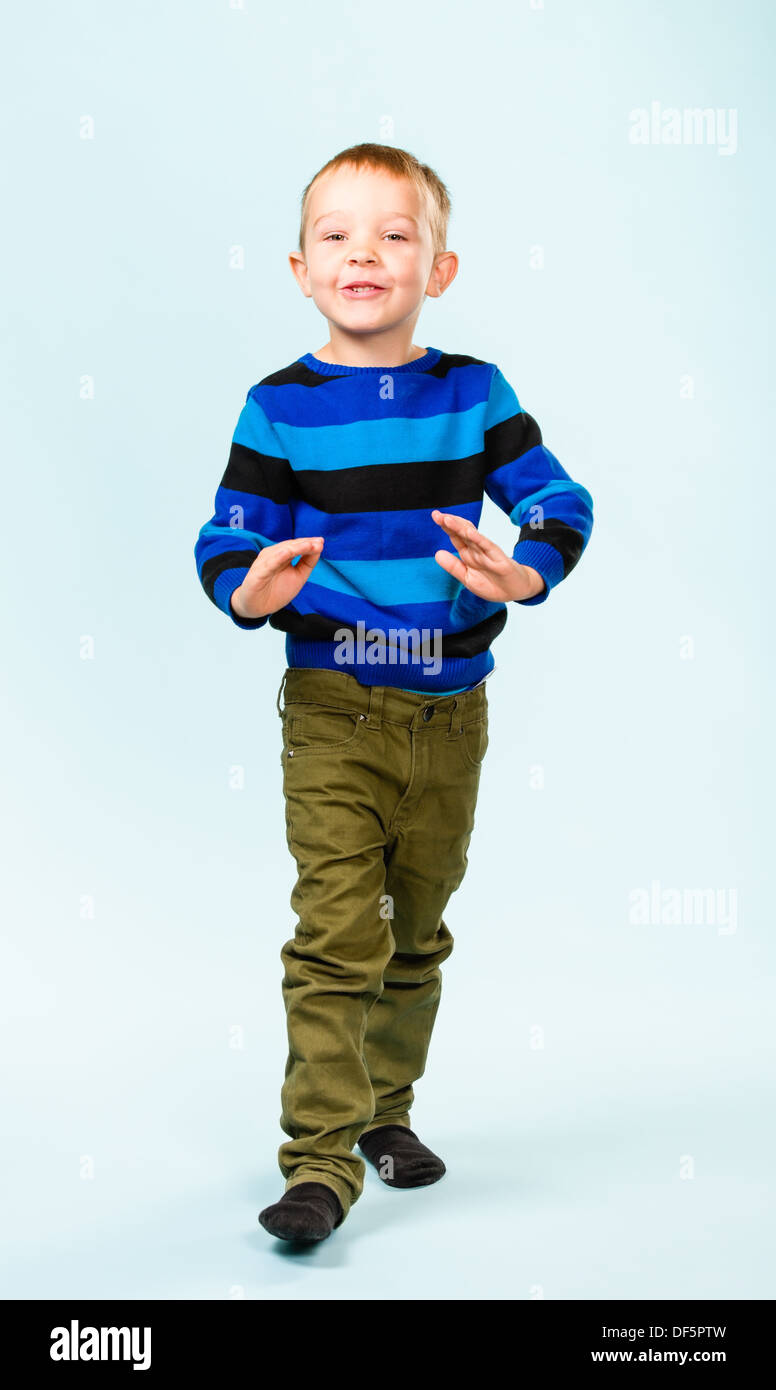 Playful little boy on studio, light blue background Stock Photo - Alamy